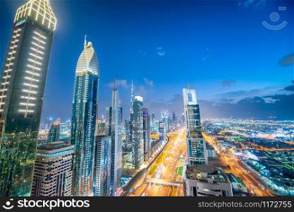 Amazing aerial view of Downtown Dubai at twilight. Skyscrapers and Sheikh Zayed Road.