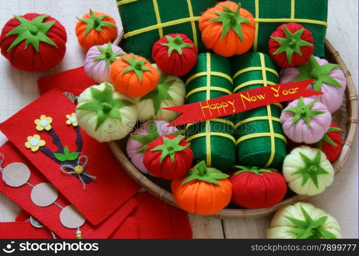 Amazing background on Tet holiday in Vietnam, banh tet, banh chung or glutinous rice cake make handmade from colorful material, harmony concept with Happy New Year message, traditional Lunar New Year