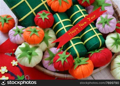 Amazing background on Tet holiday in Vietnam, banh tet, banh chung or glutinous rice cake make handmade from colorful material, harmony concept with Happy New Year message, traditional Lunar New Year