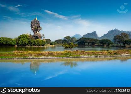Amazing Buddhist Kyauk Kalap Pagoda under blue sky. Hpa-An, Myanmar (Burma) travel landscapes and destinations