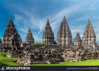 Amazing Candi Prambanan or Rara Jonggrang, largest Hindu temple site in Indonesia. Yogyakarta, Java. Religious building of tall and pointed architecture and ancient ruins in front of it