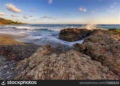 Amazing coast view near Santiago de Cuba. Splash of seawater at rocks on the shore. Sea waves over the rocks.