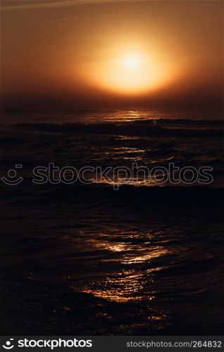 Amazing colorful red sunset over evening sea horizon. Tranquil scene. Natural background. Landscape.. Beatiful red sunset over sea surface