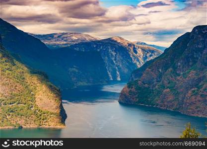 Amazing dramatic view of the fjords and mountains. Aurlandsfjord fjord landscape in Norway Scandinavia. National tourist road known as The snow road.. Fjord landscape Aurlandsfjord in Norway