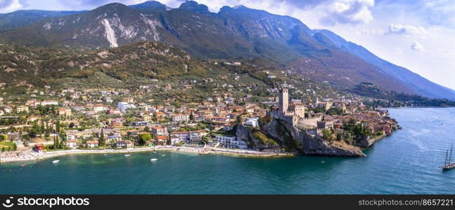 Amazing italian lake scenery - beautiful Lago di Garda. Aerial  view of Malcesine castle ,vilage and beach