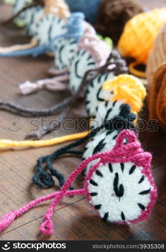 Amazing knitted clock, group of colorful watch make from yarn to happy new year, wonderful idea for handmade hobby, in warm color, abstract art