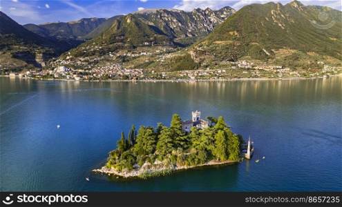 Amazing lake Iseo scenery with picturesque small island Loreto with castle, aerial drone view. Italy, Brescia province