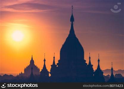 Amazing misty sunrise colors and silhouette of ancient Buddhist Temples at Bagan Kingdom, Myanmar (Burma). Travel landscapes and destinations