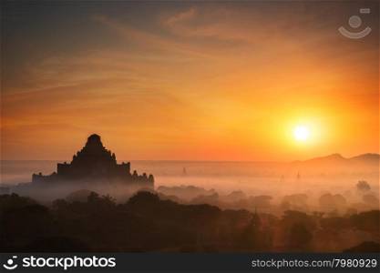 Amazing misty sunrise colors and silhouette of ancient Dhammayan Gyi Pagoda. Architecture of old Buddhist Temples at Bagan Kingdom, Myanmar (Burma). Travel landscapes and destinations