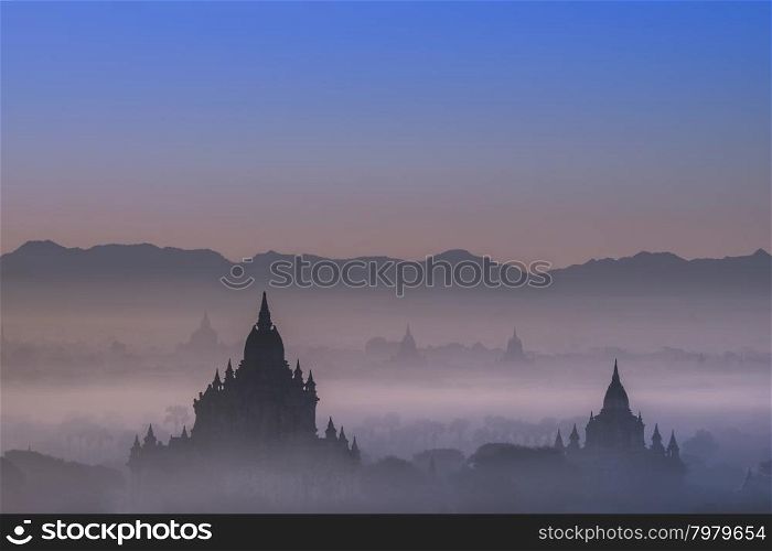 Amazing misty sunrise colors and silhouettes of ancient Sulamani and Tha Beik Hmauk Gu Hpaya. Architecture of old Buddhist Temples at Bagan Kingdom, Myanmar (Burma). Travel landscapes and destinations