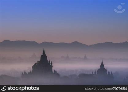 Amazing misty sunrise colors and silhouettes of ancient Sulamani and Tha Beik Hmauk Gu Hpaya. Architecture of old Buddhist Temples at Bagan Kingdom, Myanmar (Burma). Travel landscapes and destinations