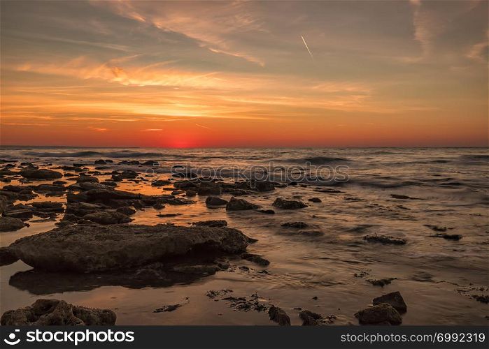 Amazing morning long exposure seascape with colorful sky over the water