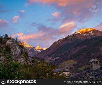 Amazing panorama of the snow-covered Orobie mountains of the Seriana Valley and the Sedornia Valley at sunset.