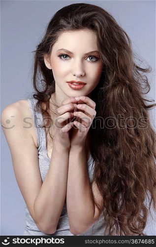 amazing portrait of a young and fresh nice girl with T-shirt and curly brown hair