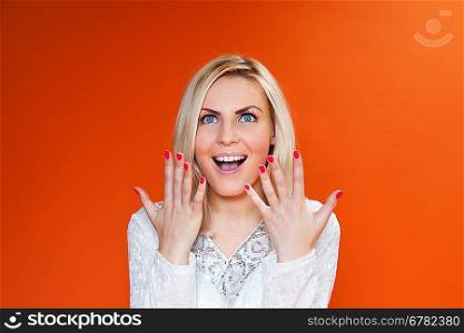 Amazing sexy blonde! Lady against orange background wearing fashionable dress studio shot.