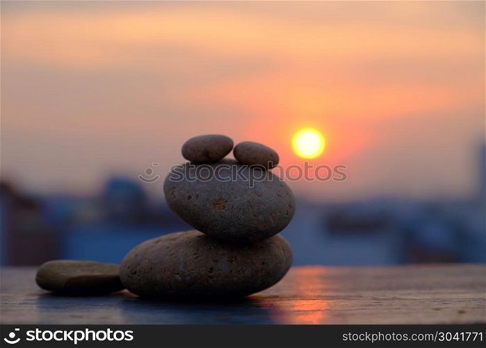 amazing shape, frog from pebble stone. Arrangement art from boulder make amazing shape as frog on sunrise sky, yellow sun and pebble stone in silhouette, stack of rocks balance make abstract background