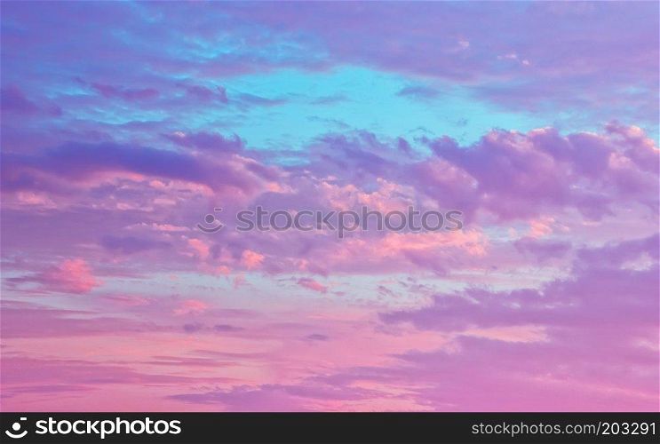 Amazing sky background - pink and serene fluffy cumulus clouds in the blue sky. Season of the white nights. The Republic of Karelia, Russia.. Pink And Serene Fluffy Cumulus Clouds In The Sky