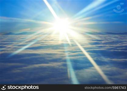 Amazing sky view from plane on blue sunset, sun and clouds
