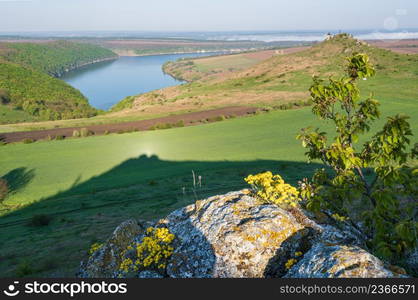 Amazing spring view on the Dnister River Canyon with picturesque rocks, fields, flowers. This place named Shyshkovi Gorby, Nahoriany, Chernivtsi region, Ukraine.