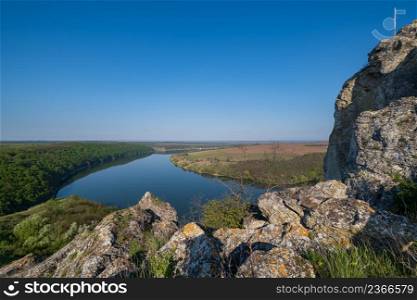 Amazing spring view on the Dnister River Canyon with picturesque rocks, fields, flowers. This place named Shyshkovi Gorby, Nahoriany, Chernivtsi region, Ukraine.