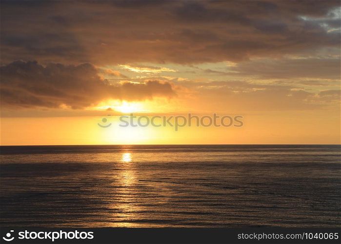 Amazing sunrise at sea in the morning with bright sun and clouds in the sky