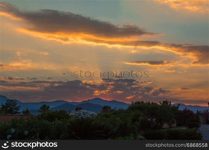 Amazing Sunset among Hills and Clouds
