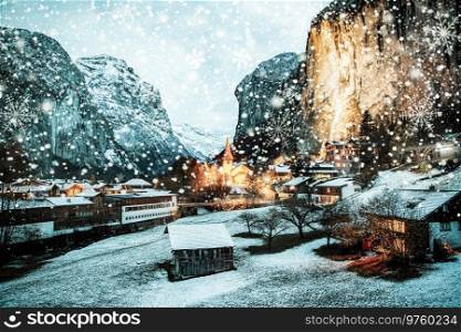 amazing touristic alpine village at night in winter with famous church and Staubbach waterfall  Lauterbrunnen  Switzerland  Europe