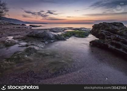 Amazing tranquility sea and rocky coast before sunrise