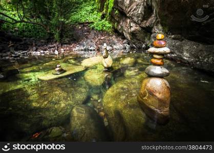 Amazing tropical rain forest landscape with lake and balancing rocks tower for zen meditation practice. Nature background