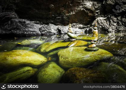 Amazing tropical rain forest landscape with lake and balancing rocks tower for zen meditation practice. Nature background