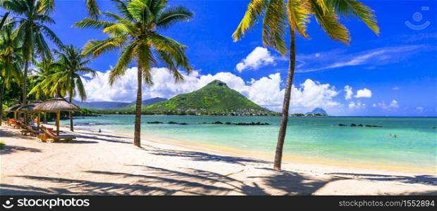 Amazing tropical scenery of beautiful beach and mountain view. Flic en Flac, Mauritius island. Flic en Flac beach, Mauritius island