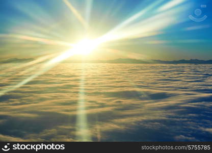 Amazing view from plane on the sky, sunset sun and clouds