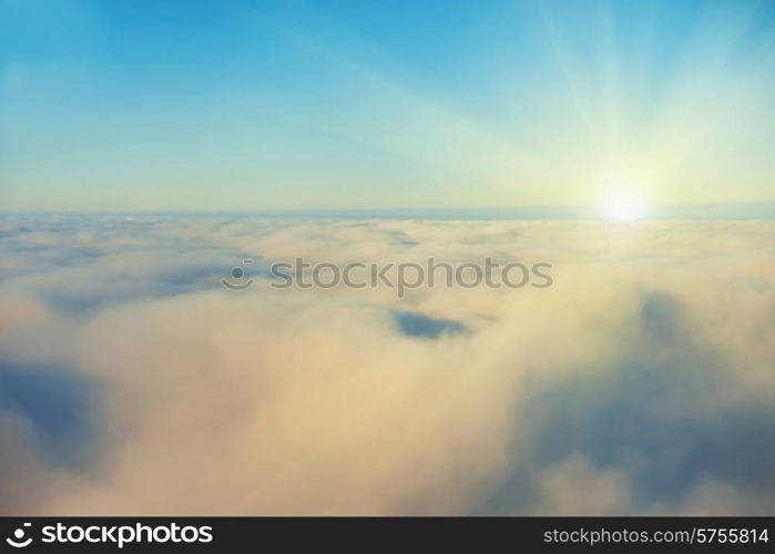 Amazing view from plane on the sky, sunset sun and clouds