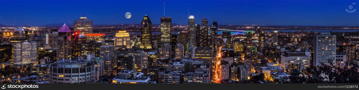 Amazing view of Montreal city at sunset with colorful neon light building. Montreal panorama at dusk as viewed from the Mount Royal overlook. Magic moon over Canadian city.