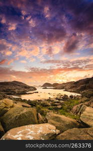 Amazing view sunset over the nordic rocks on the most southern point of Norway in Lindesnes, South Cape, Vest-Agder, Norway. Coastline at sunset in Norway