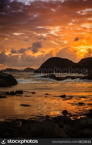Amazing view sunset over the nordic rocks on the most southern point of Norway in Lindesnes, South Cape, Vest-Agder, Norway. Coastline at sunset in Norway