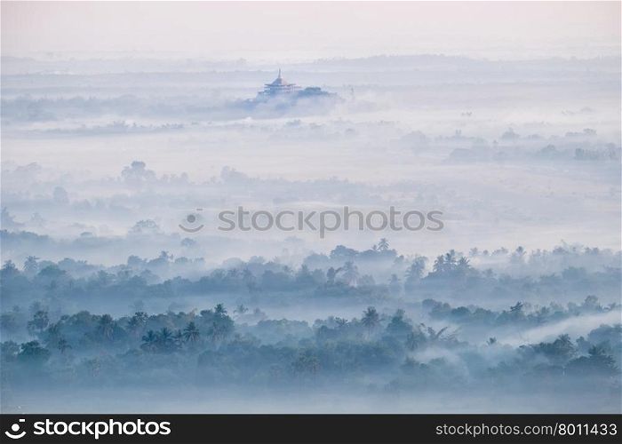 Amazing watercolor view of foggy morning landscape with farm fields and Gabar Lone Pagoda in mist at Thanlwin river. Hpa An, Myanmar (Burma) travel landscapes and destinations