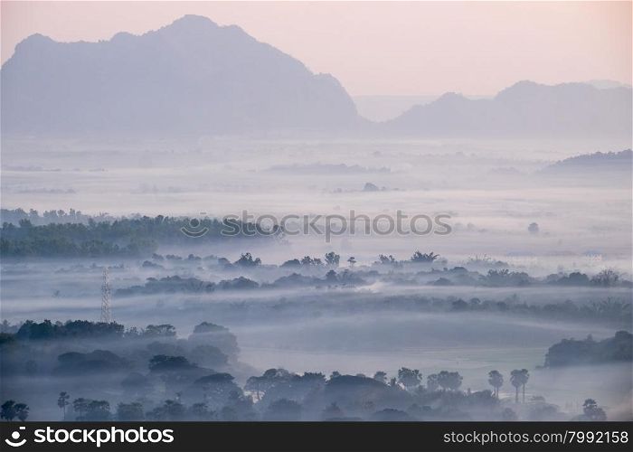 Amazing watercolor view of foggy morning landscape with farm fields at Thanlwin river. Hpa An, Myanmar (Burma) travel landscapes and destinations