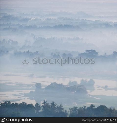 Amazing watercolor view of foggy morning landscape with farm fields at Thanlwin river. Hpa An, Myanmar (Burma) travel landscapes and destinations