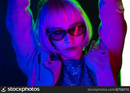Amazing woman with dyed pink hairstyle dancing on led-colorful neon l&s background. Charming lady, night life concept. Modern pop outfit, influencer lifestyle. High quality photo. Amazing woman with dyed pink hairstyle dancing on led-colorful neon l&s background. Charming lady, night life concept. Modern pop outfit, influencer lifestyle.