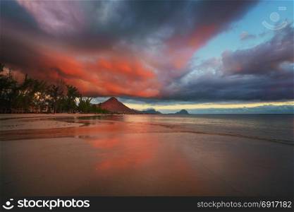 "Amazng sunset in "flic and flac" beach at Mauritius Island with awesome red/orange cloud."