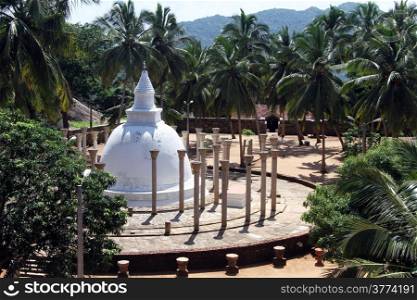 Ambasthala stupa with columns and palm trees in Mihintale, Sri Lanka