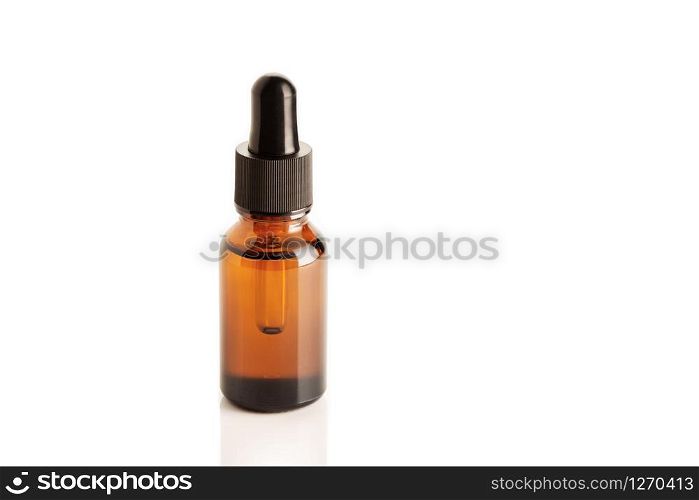 Amber Bottle with dropper isolated on white background. Copy space