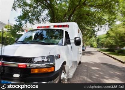 Ambulance vehicle travelling to accident, motion blur to give sense of speed