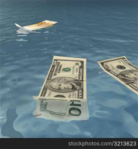 American and Euro bank notes floating on water