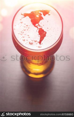 American beer concept, America silhouette on foam in beer glass on black table, view from above