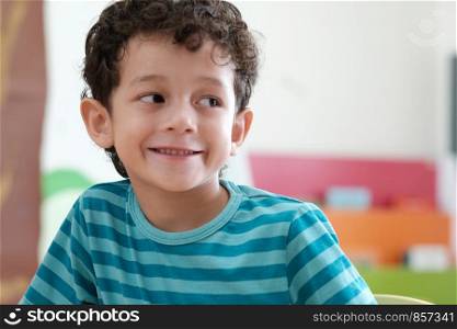 American boy in kindergarten classroom, kid education concept