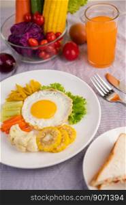 American breakfast on a white background with fried egg, salad, pumpkin, cucumber, carrot, corn, cauliflower, tomato, toast and orange juice.
