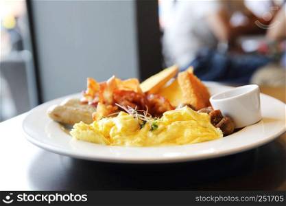 American Breakfast with bacon , scrambled egg on wood background