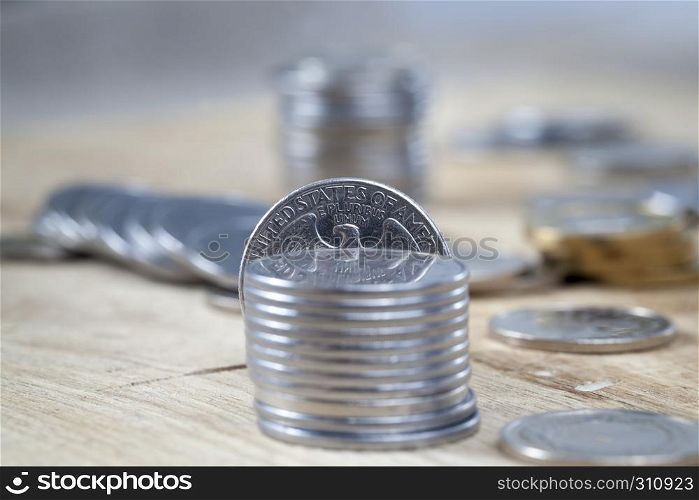 American coin quarter dollar lying together with other coins on the board. quarter dollar stack